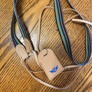 Consuela narrow strap with luggage tag charm